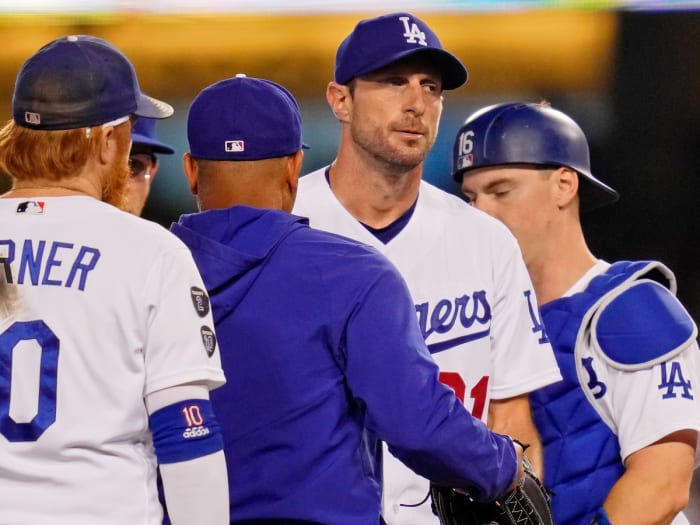 Los Angeles Dodgers starting pitcher Max Scherzer (31) reacts as manager Dave Roberts (30) takes him out of the game against the St. Louis Cardinals during the fifth inning at Dodger Stadium.